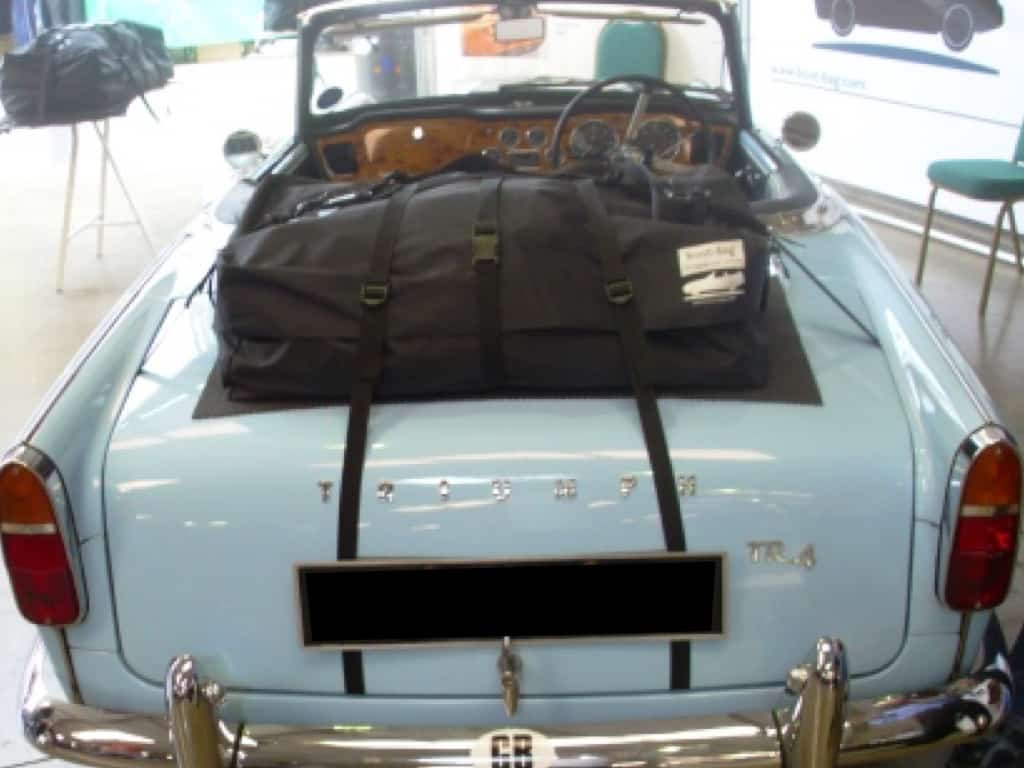 light blue triumph tr4 with a boot-bag luggage rack system fitted to the boot