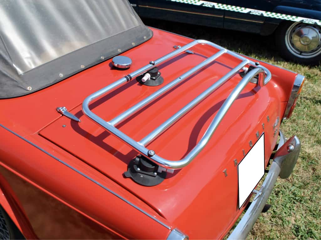side view close up of a revo-rack luggage rack fitted to a red triumph tr4