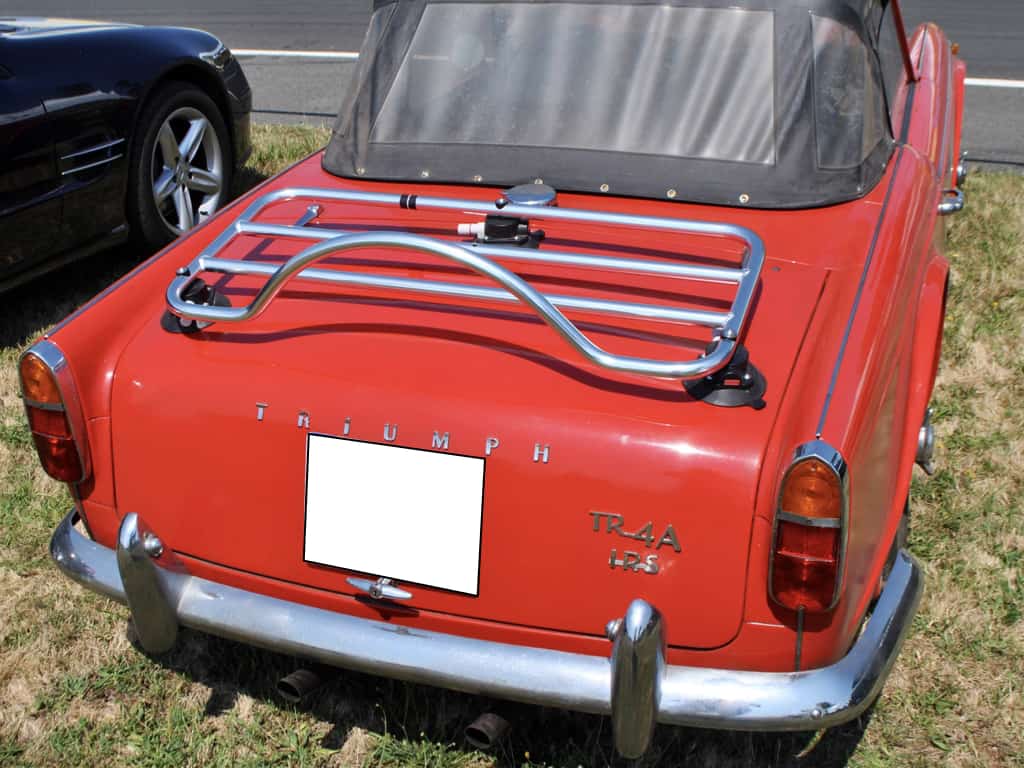 Red Triumph TR4A With a chrome luggage rack fitted to the boot