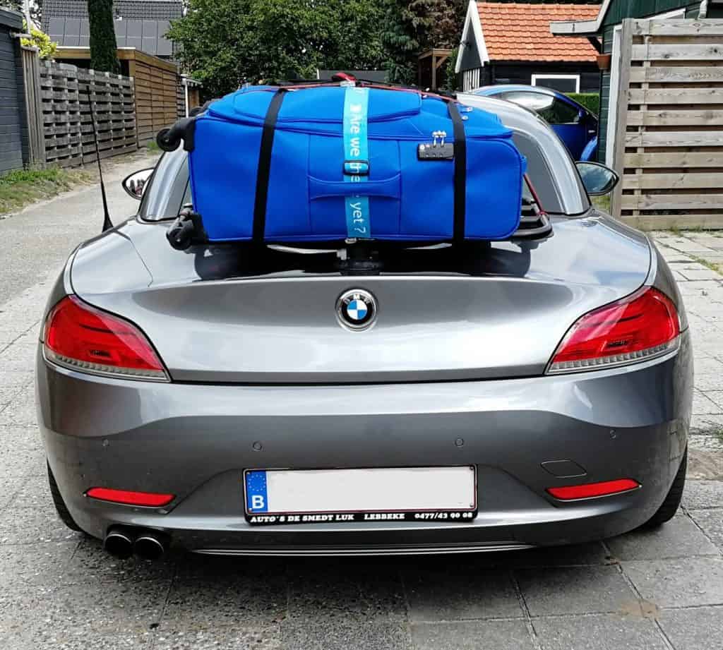 silver bmw z4 e89 with a revo-rack luggage rack fitted carrying a large blue suitcase 