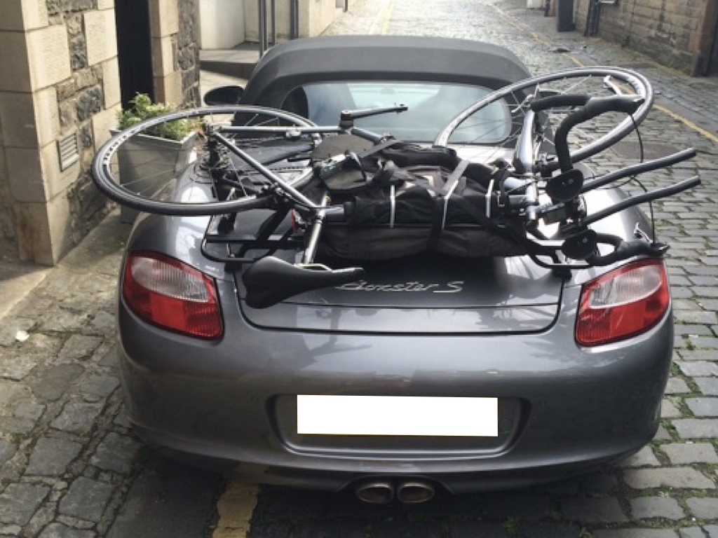 grey porsche boxster 987 with a bike rack fitted carrying a bicycle