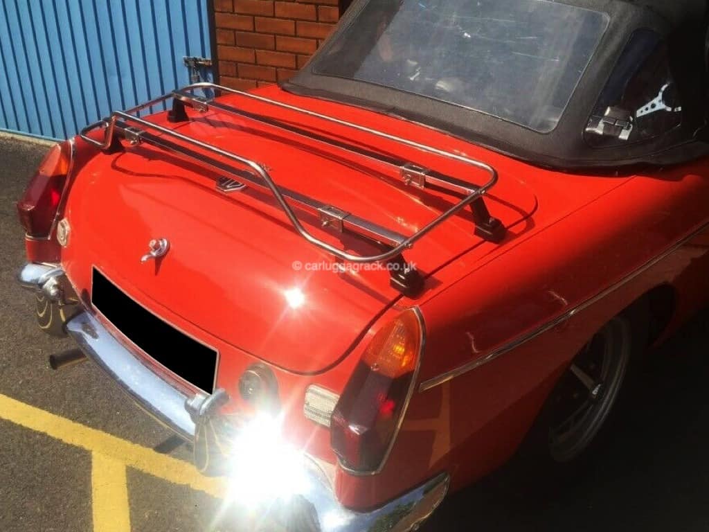 side view of an orange mgb with a stainless steel boot rack fitted