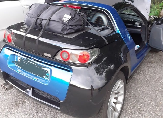 black and blue smart roadster with a boot-bag luggage rack fitted