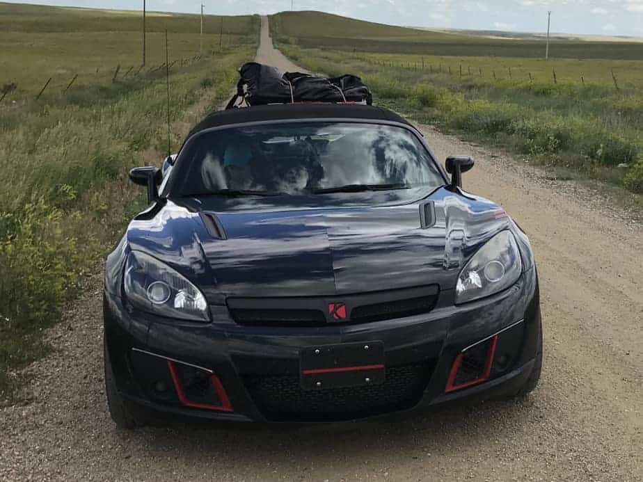 black convertible on dusty country road with a revo-rack luggage rack fitted