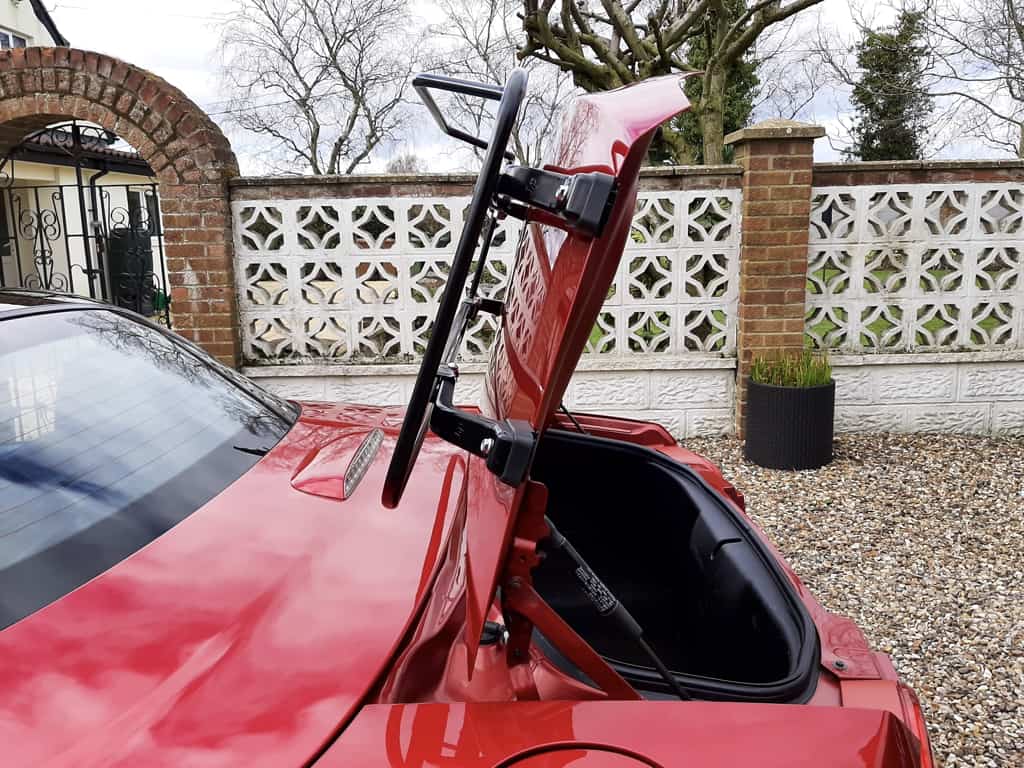 side view of a mazda mx5 mk3 with a luggage rack fitted and the boot open