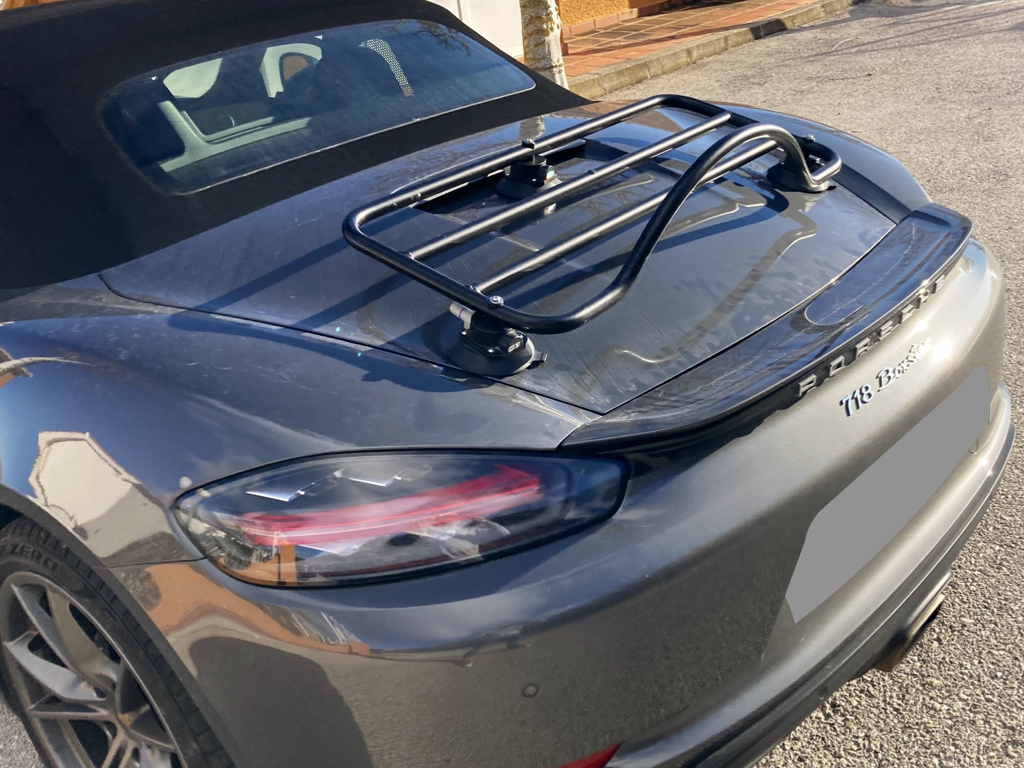 dark grey porsche boxster 718 with a revo-rack black luggage rack fitted to the boot lid photographed close from the side
