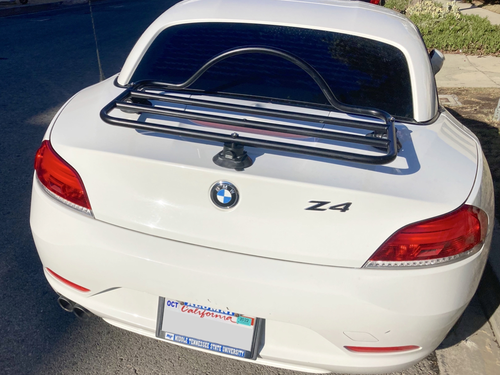 white bmw z4 in LA parked on a street with a black luggage rack fitted to the trunk