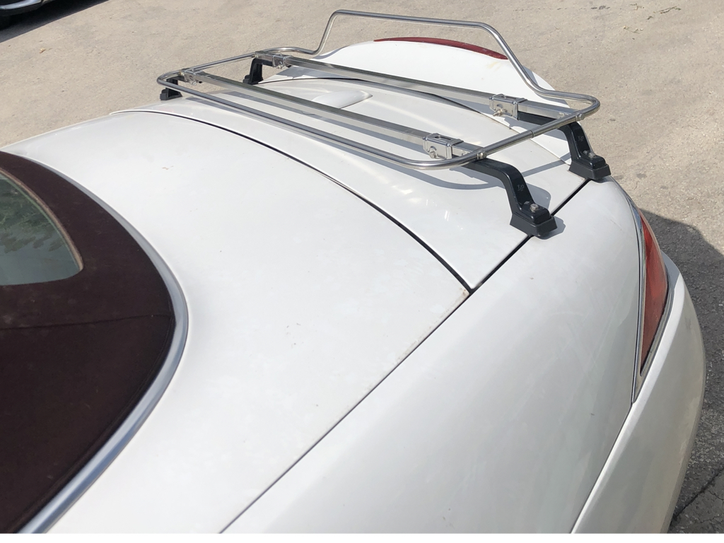 white Jaguar xk convertible with a stainless teel boot rack fitted 
