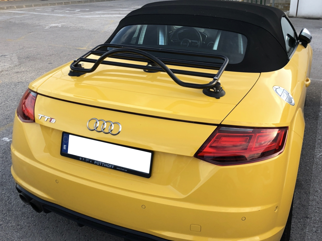 Yellow Audi TT Roadster in a car park with a black revo-rack luggage rack fitted photographed close at the rear