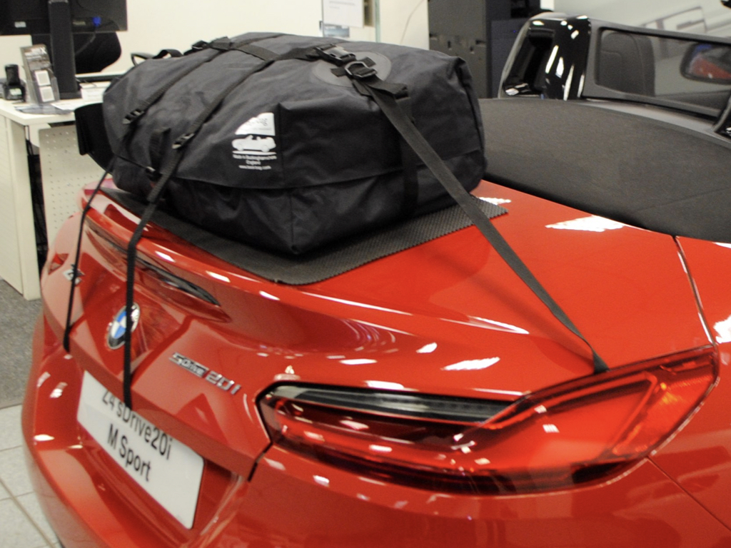 red bmw z4 g29 20i with a boot-bag luggage rack fitted in a bmw showrom