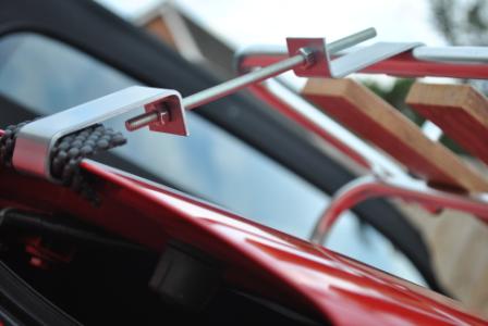 close up of fitting brakets for wood and chrome car luggage rack