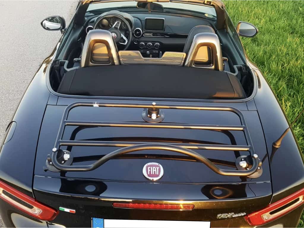 Black Fiat 124 with modern black luggage rack attached with hood down