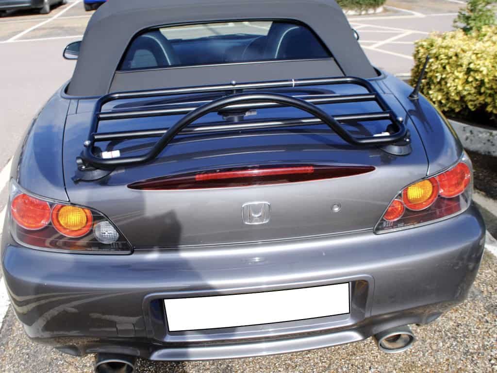 Grey Honda S2000 with modern black luggage rack attached in the sunshine