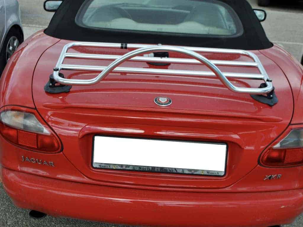Red Jaguar XK with black hood and modern chrome revo rack luggage rack attached
