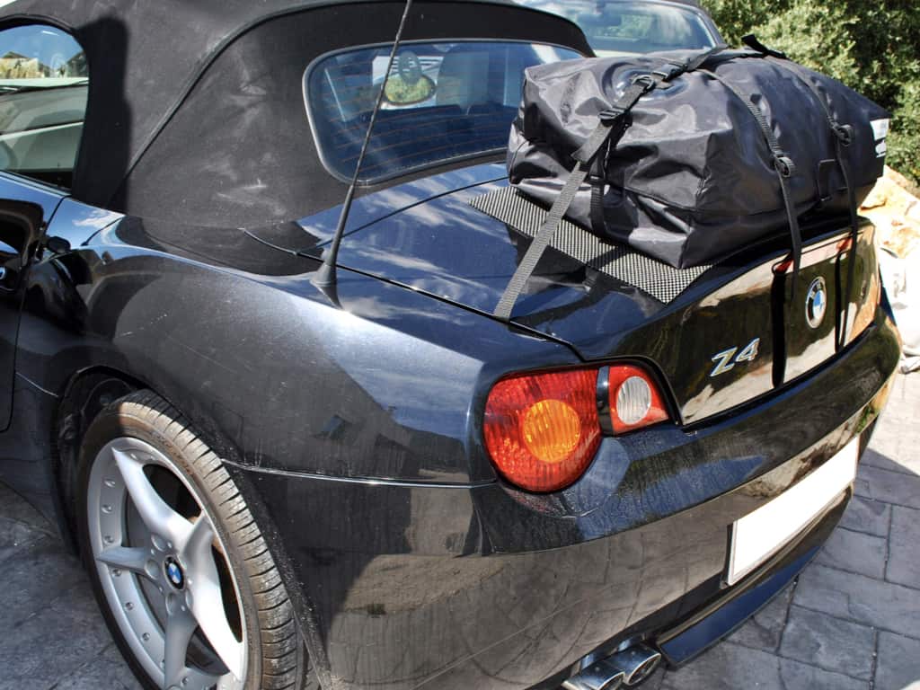 Black BMW Z4 E85 with luggage carrier attached on a sunny day