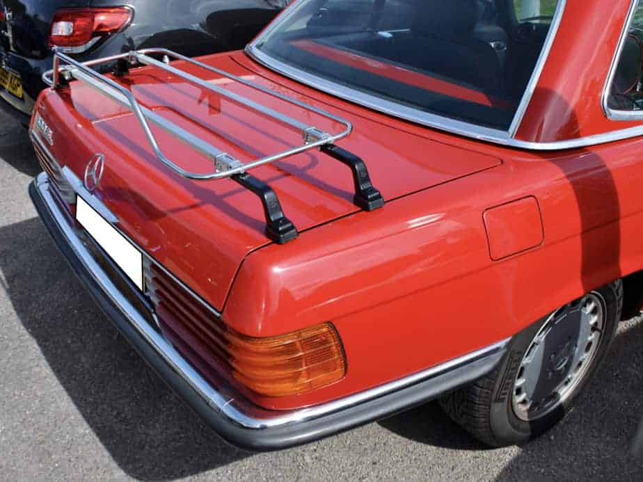 Red Mercedes SL with chrome luggage rack attached