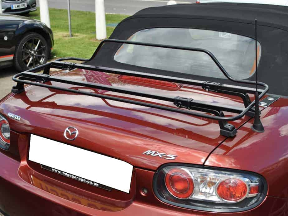 Red Mazda MX5 MK3 with Italian Black luggage rack attached with hood up