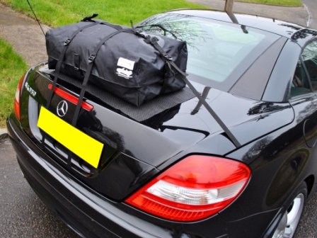 Black Mercedes SLK 350 with Boot Bag attached in the garden photographed from the side